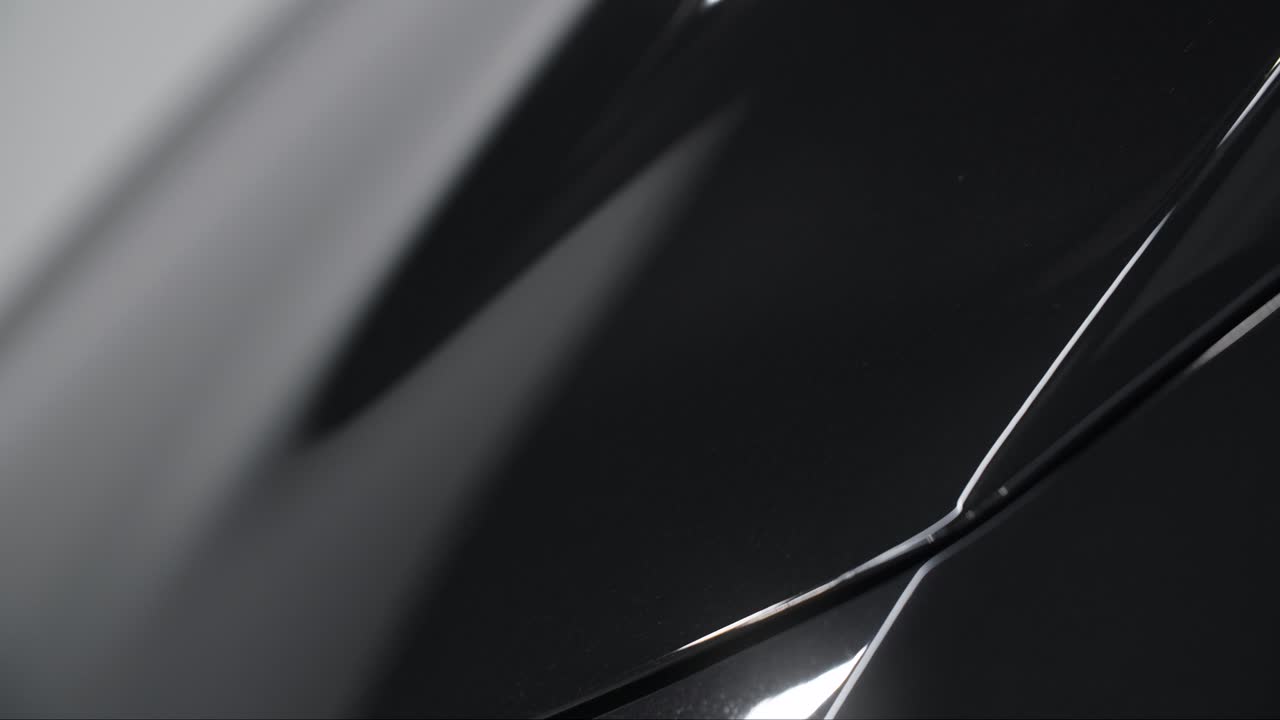 Close-up view of a polished black car body