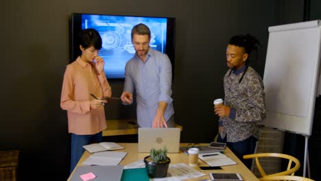 Business-colleague-discussing-over-laptop-in-office-4k