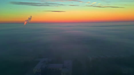 sunrise over foggy cityscape