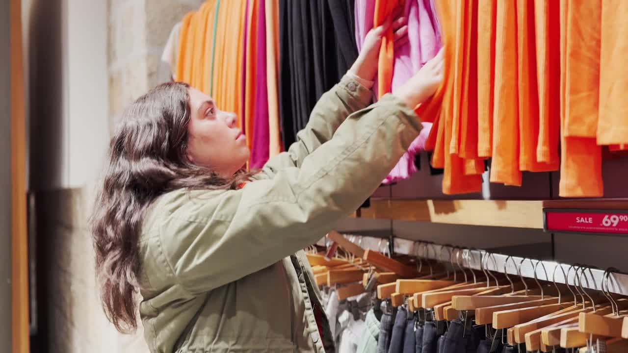 A woman is shopping for clothes in a store