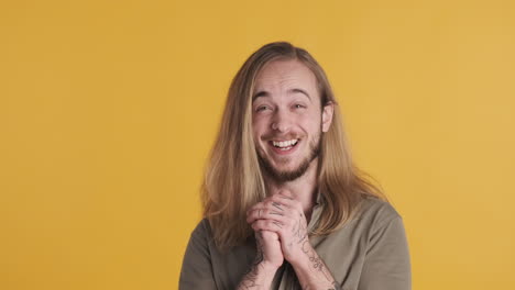 caucasian young man laughing in front of the camera.