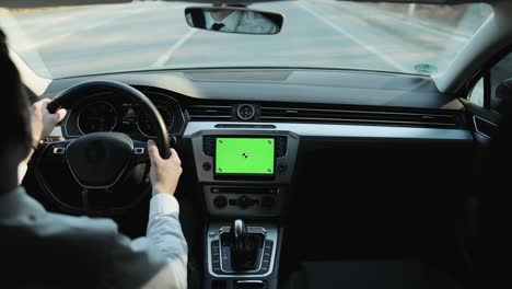 back view of classic casual businessman in white shirt using smart watch on his hands while driving a car with greenscreen mock-up display dashboard service menu application. navigation. map. driver