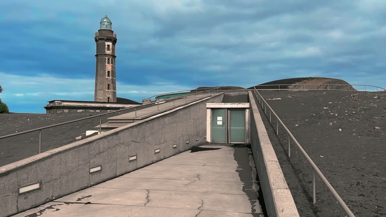 View of the underground entrance to the Capelinhos Volcano Interpretation Center, built beneath volcanic ash beside the historic lighthouse on Faial Island