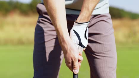 man preparing to swing golf club