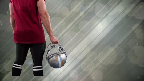 animation of caucasian amercian football player over light trails and spots on grey background