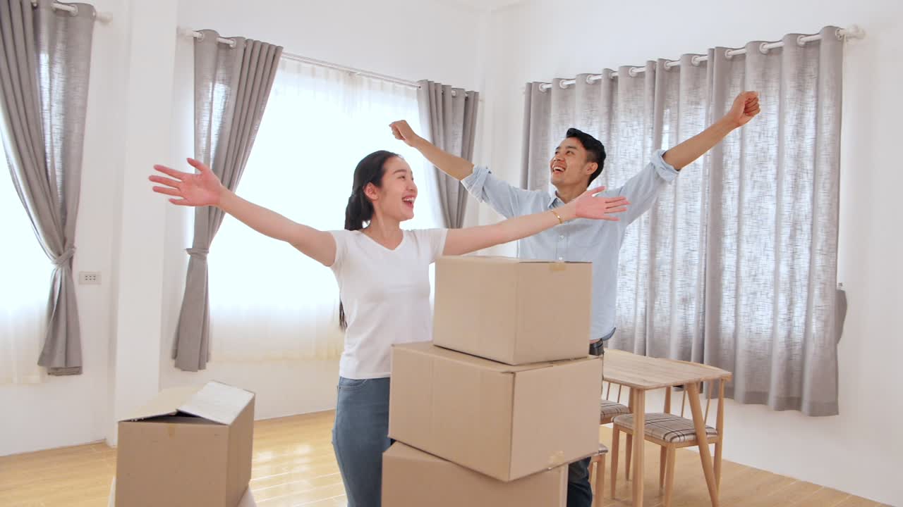 Happy Asian Couple In New House At Moving Day
