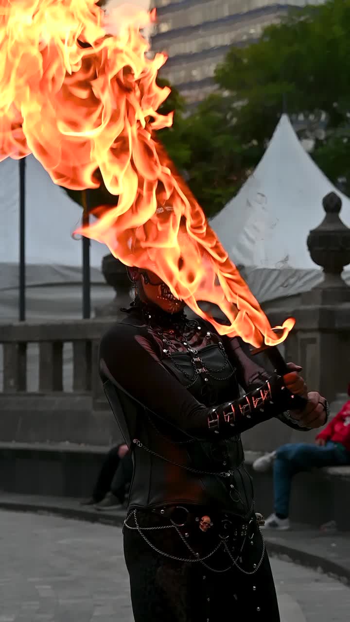 A woman dressed as a catrina shows off striking skeleton makeup as she swings a flaming katana in slow motion during the Day of the Dead festivities