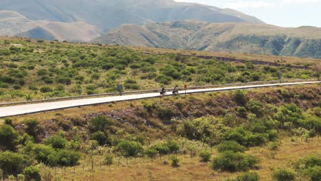 bird's eye view approaching cyclists and a car crossing route 9 in northeastern argentina