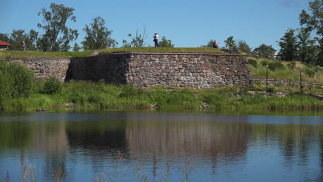 The-stone-wall-view-of-Korela-Fortress-with-lake,-filled-with-interesting-art-and-unique-appearance-at-Russia