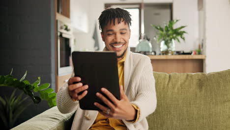 man having a video call on a tablet at home