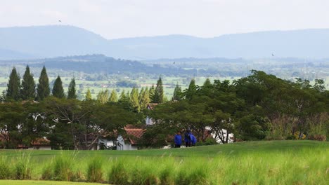 people walking across a scenic rural backdrop.