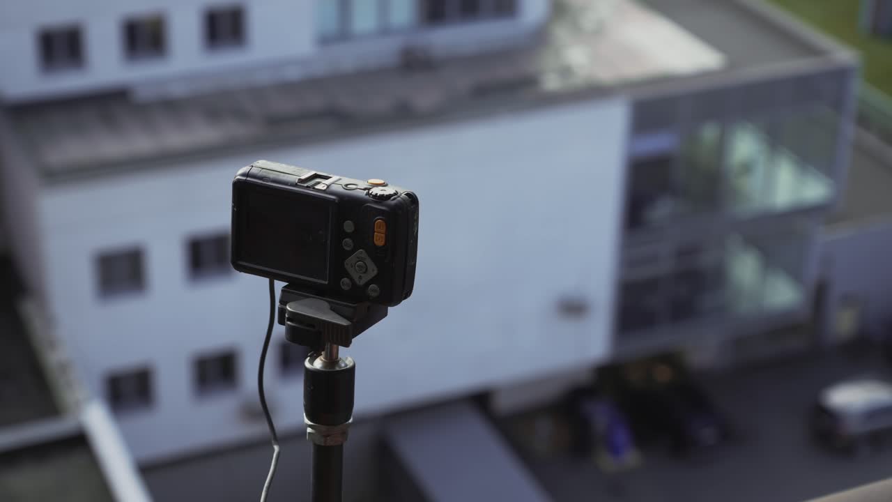 Surveillance Camera overlooks soft focus city office buildings Ostrava
