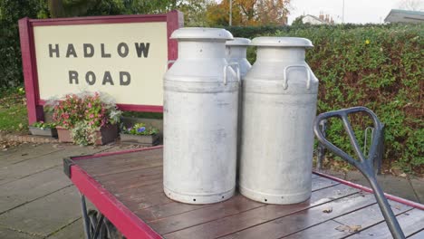 Retro-Steel-milk-churns-on-hand-cart-Hadlow-Road-train-platform