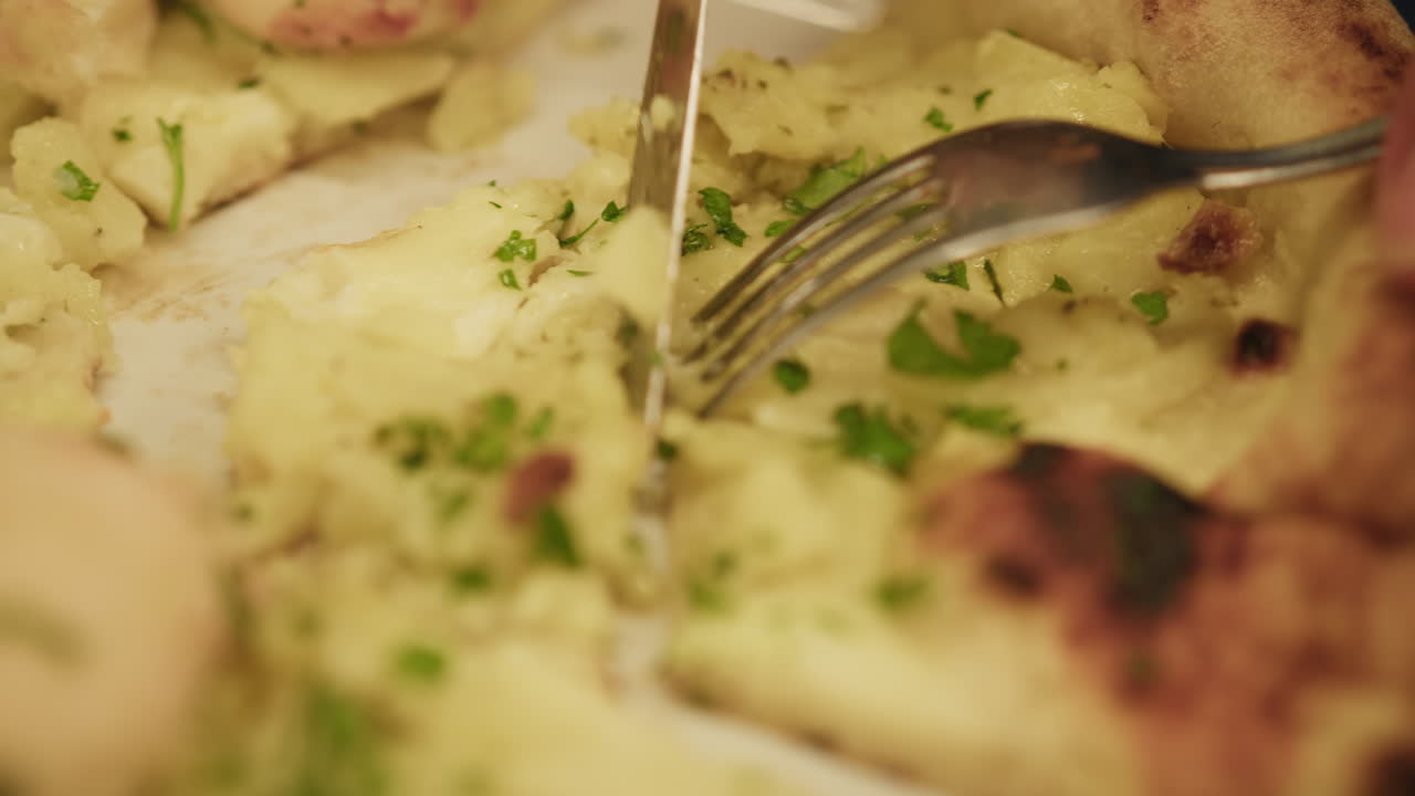 Details Of Fork And Knife Slicing A Gourmet Pizza With Octopus