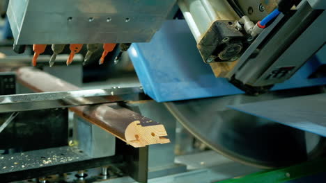manufacturing doors. modern industrial equipment for making furniture. machine tool cutting wooden board. close-up.