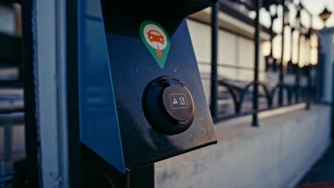 man charging electric car at a public charging station