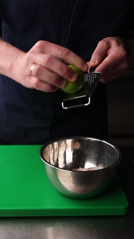 chef preparing lime zest for seafood dish