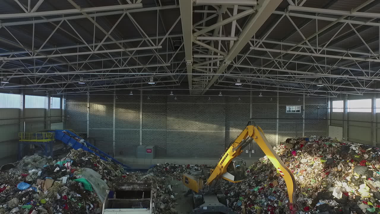 창고 덤프에서 굴삭기가 쓰레기를 옮기는 햇볕에 쬐인 개요