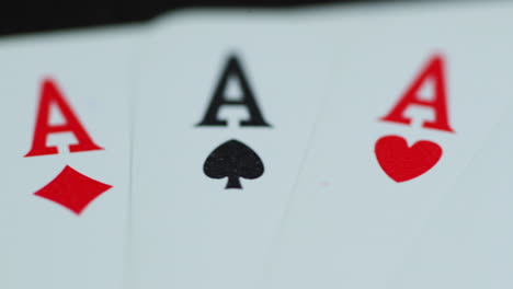 a close up macro shot of playing cards with all four aces hearths diamonds space cross lying on an elephant while moving as the cards slowly expose from the side