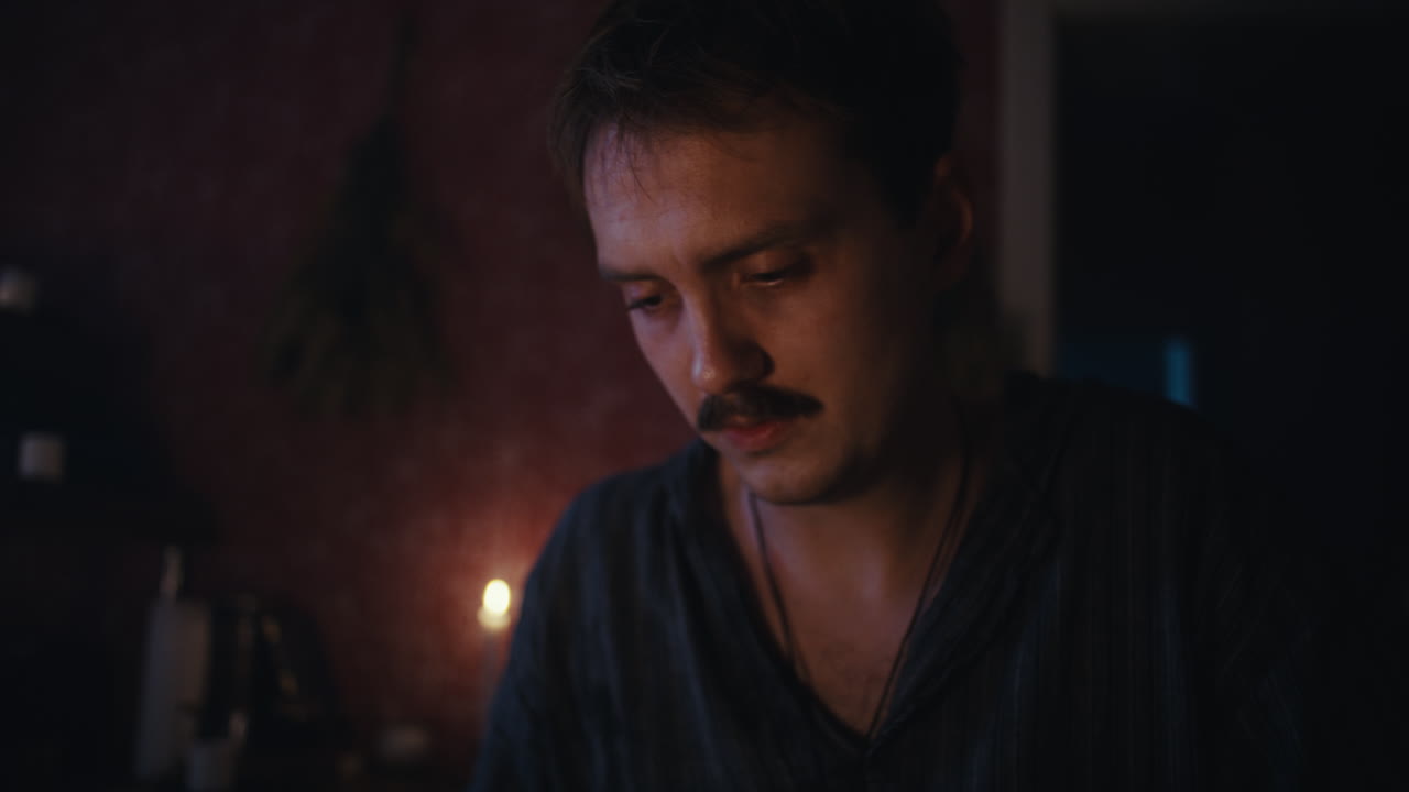 Man Examining a Mysterious Jar by Candlelight