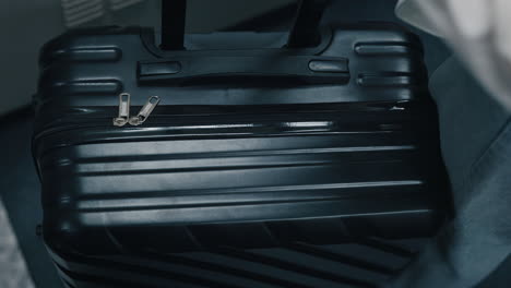 black suitcase on a train