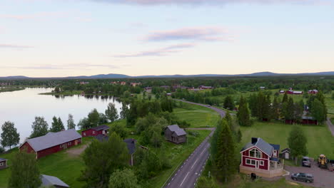 aerial drone fly above pristine sweden lapland village street lake green field unpolluted natural atmosphere