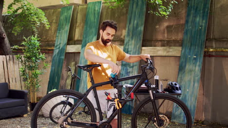 man moving bicycle to repair-stand