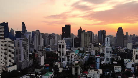Aerial-Descending-Panning-Shot-of-Bangkok's-Skyscrapers-at-Sunrise