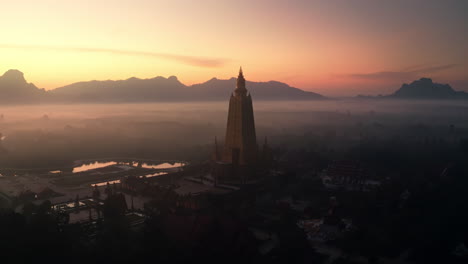 sunrise over a golden pagoda in thailand