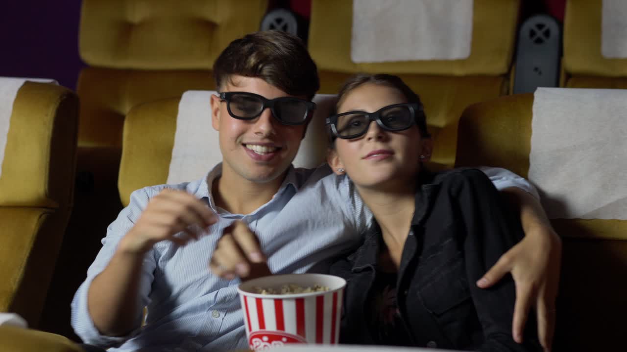 Man and woman in the cinema watching a 3D movie