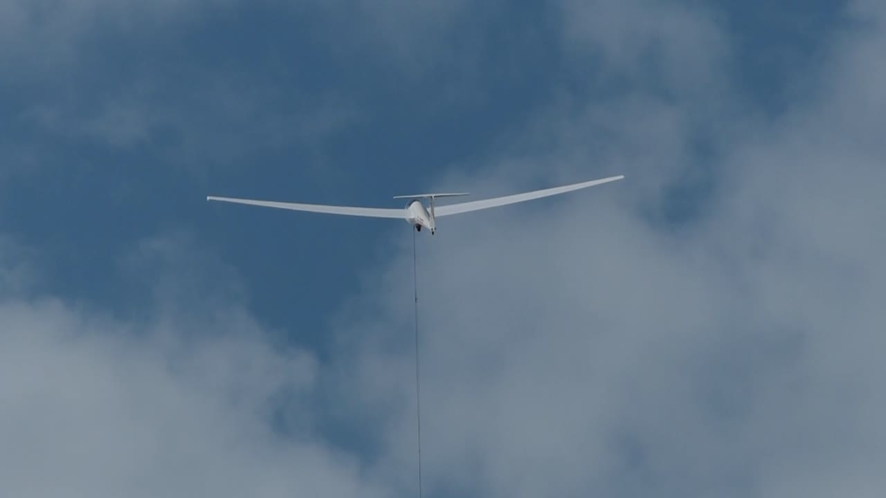 wind launch of a white glider in the sky
