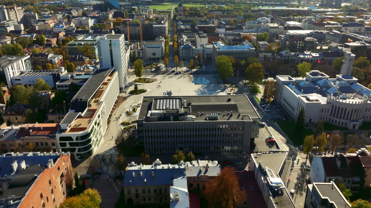 Aerial view of Kaunas Business District. Unity Square is visible in the foreground. Sports stadium "Žalgiris" is visible in the background. Bright autumn afternoon. High quality 4k prores footage.