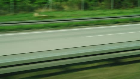 quickly go by motorway. view from the side window from the rear passenger side