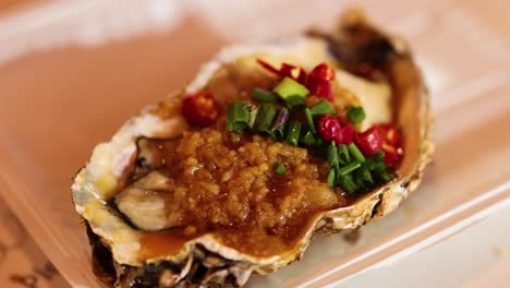 deliciously prepared oyster with vibrant garnishes