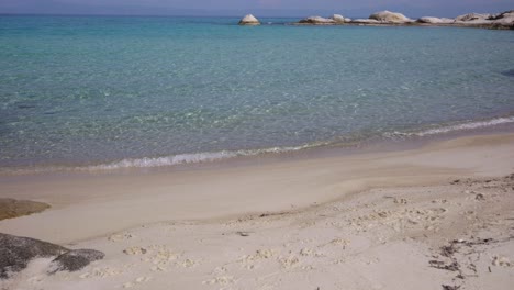 Video-clip-presenting-the-crystal-clear-waters-of-the-famous-Kavourotripes-beach-in-Sithonia,-Chalkidiki,-Greece