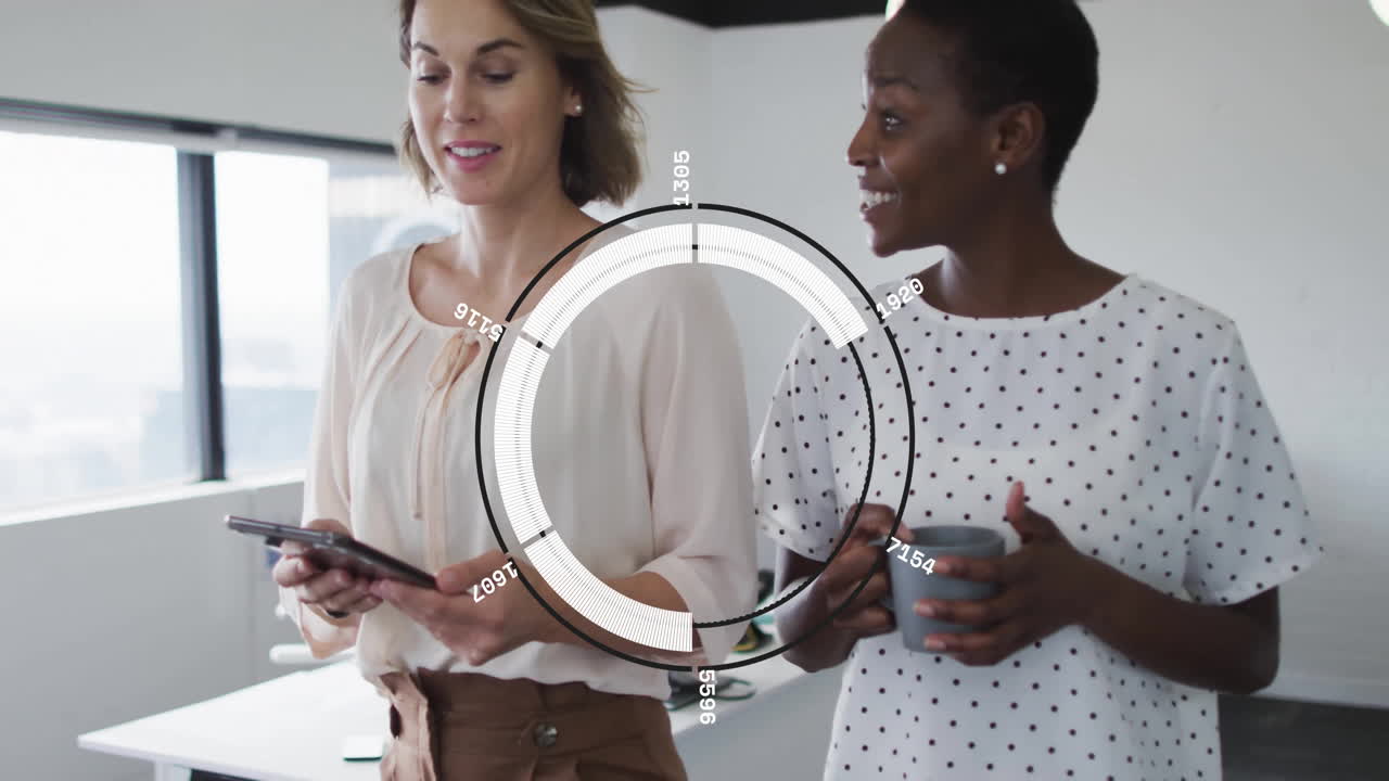 Two women in office discussing data with circular graph animation overlay