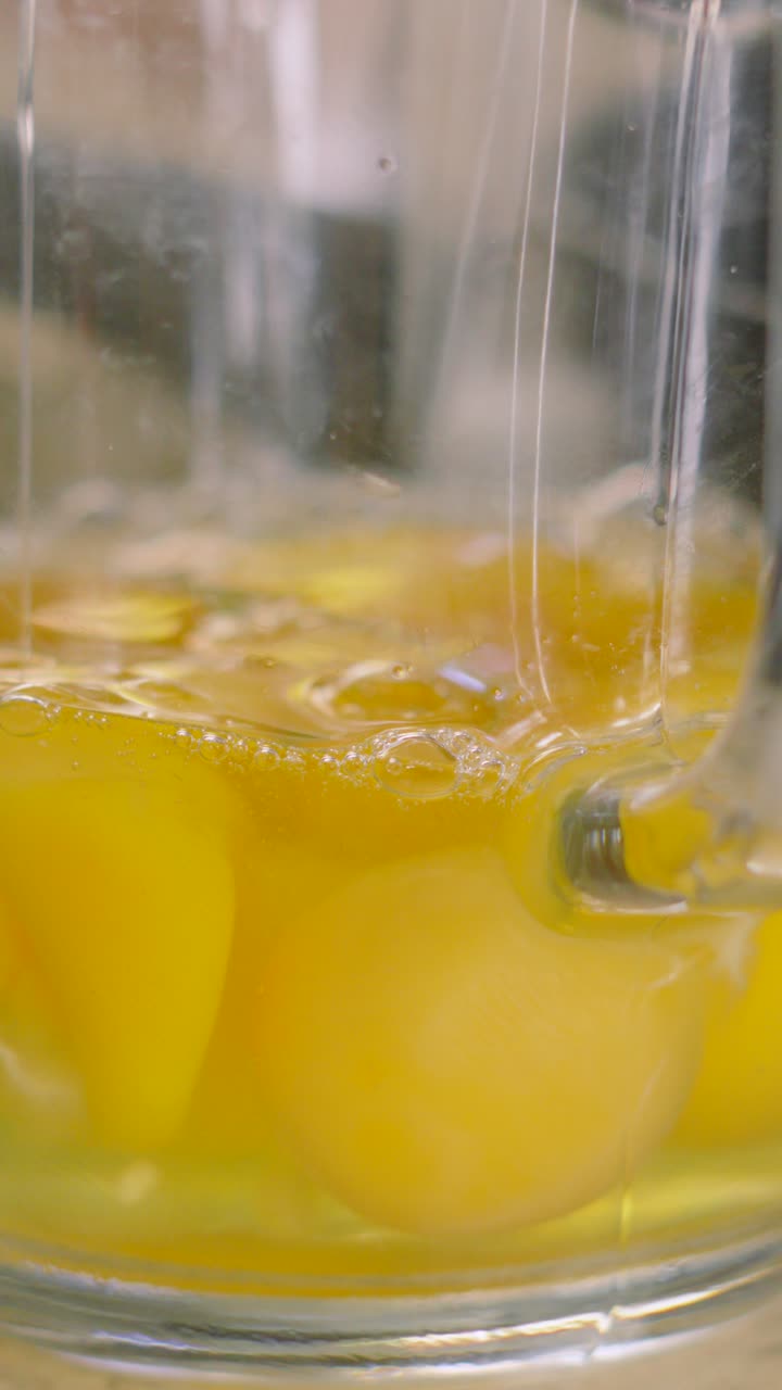 Vertical Video of Raw Eggs in Measuring Jug with One Egg Being Poured in Slow Motion. Ready to Mix to make Scrambled Eggs or Cake Mixture.