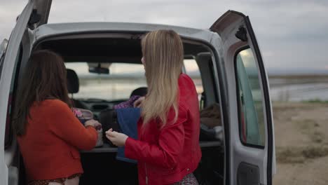 women styling hair in a van
