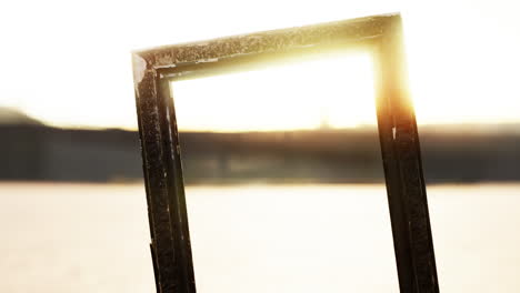 empty wooden picture frame on the beach sand