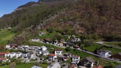 Aerial-approaching-shot-of-suburb-neighborhood-of-Trimmis,-small-town-in-Switzerland