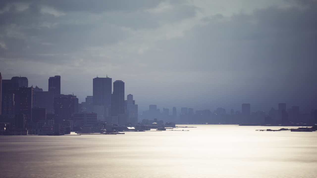 Overcast skyline view of a bustling city by the tranquil water at dusk