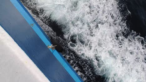 top view of sea water splashing from a sailing boat in bangkok, thailand - tracking shot