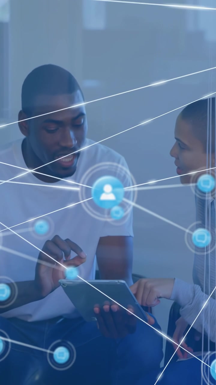 Vertical video: Man holding tablet woman pointing starting tech HUD growing into nodes for planning