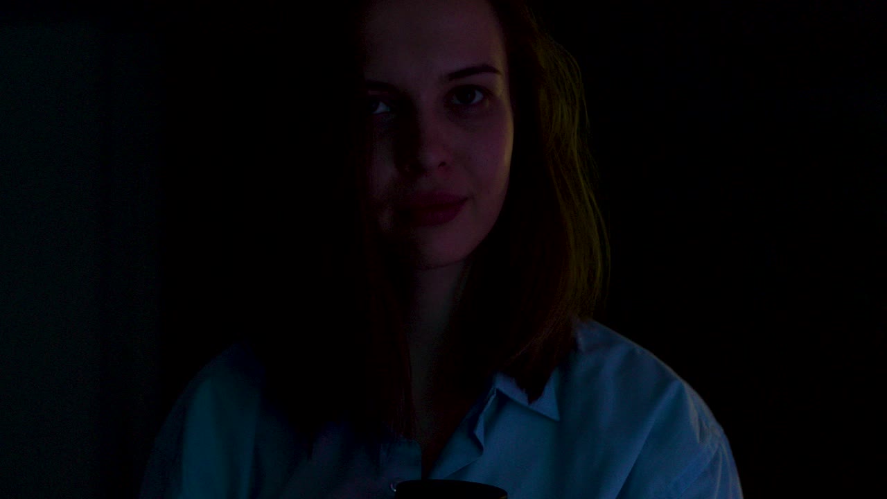 Woman with Coffee in Low Light