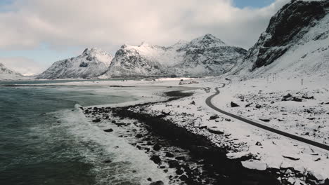 seascape at skagsanden beach in lofoten islands, nordland county, norway, europe - white snowy mountain hills, nature landscape background in winter season - drone shot