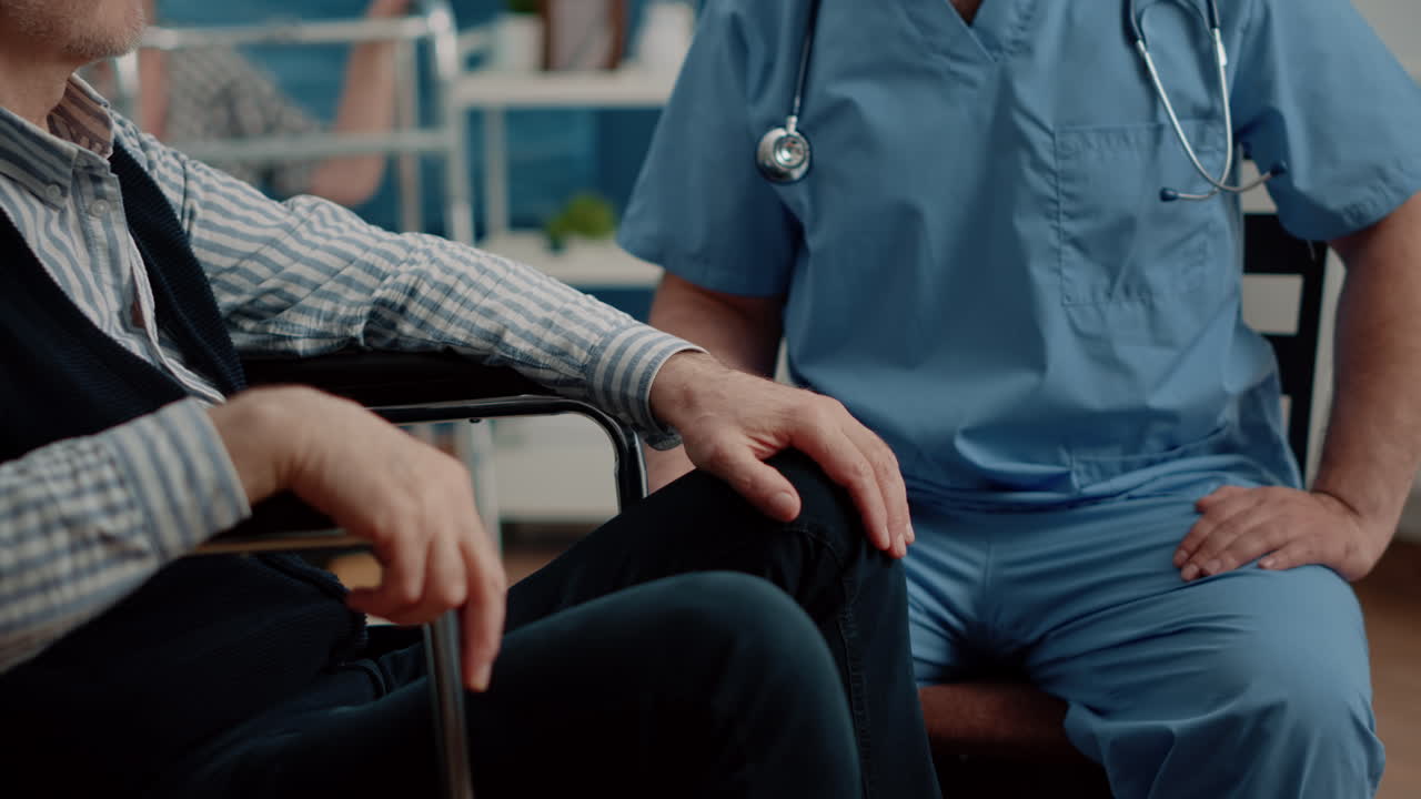 Close up of hands of man nurse comforting senior patient