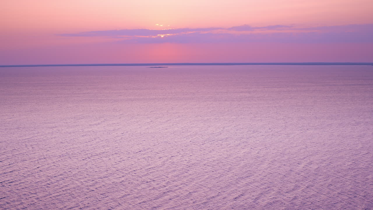 Drone shot flying over lake Michigan towards a lone uninhabited Island