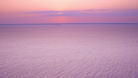 drone shot flying over lake michigan towards a lone uninhabited island