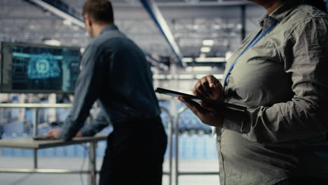 data center programmers check ai dashboard using tablet, doing systems review