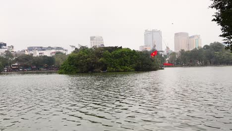 island with flag in hanoi canal